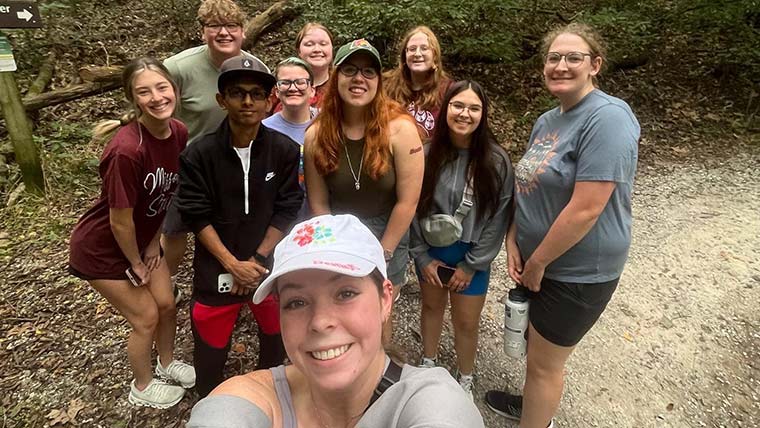 Group selfie of Missouri State Tri-Beta Biological Honors Society members along a hiking trail.