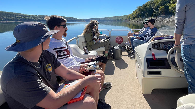 Biology students on a boat at Bull Shoals Lake.