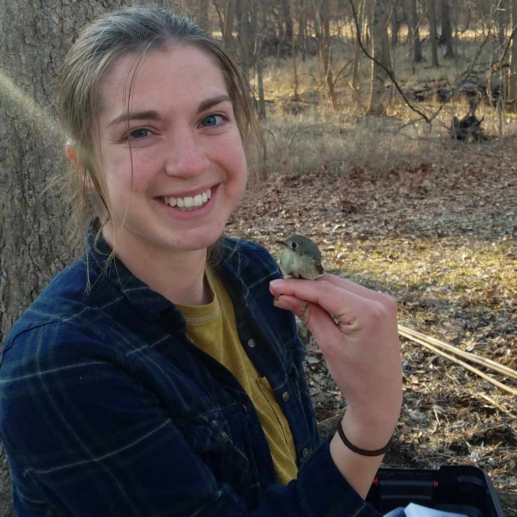 Shelby Palmer holding a chickadee in her hand